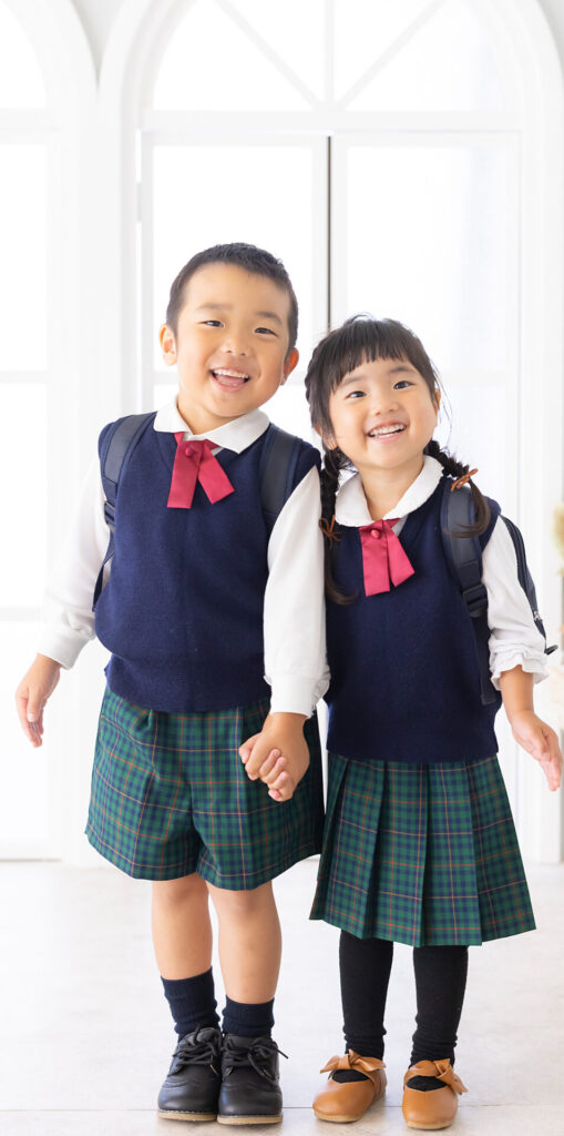 卒園の思い出に兄と妹が園服を着て仲良く並んでいる写真